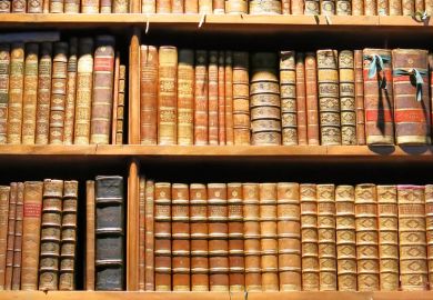 Old books arranged on library bookshelves Old books arranged on library bookshelves
