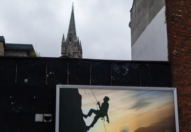 Optical illusion, image of a man climbing to the top of Catholic cathedral 