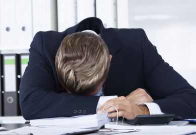 Overworked man slumped on desk Overworked man slumped on desk