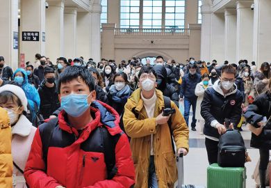 People wear face masks as they wait at Hankou Railway Station on January 22, 2020 in Wuhan, China