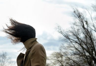 Woman with hair blown by wind