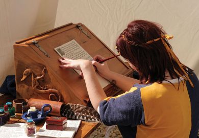 Woman writing dressed in medieval clothes Woman writing dressed in medieval clothes