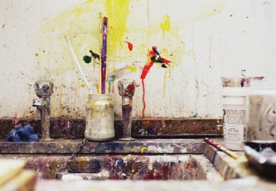 Paint and paintbrushes beside artist's kitchen sink Paint and paintbrushes beside artist's kitchen sink