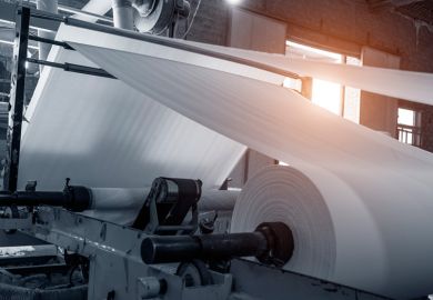 Paper being processed in paper mill Paper being processed in paper mill