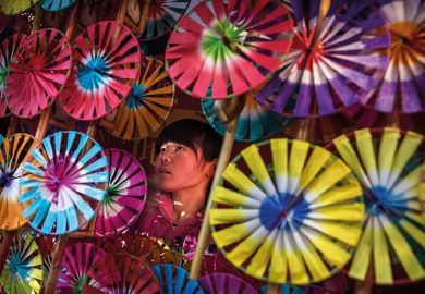 Girl surrounded by umbrellas