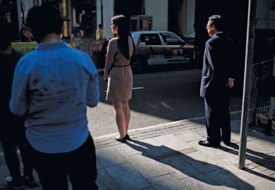 Pedestrians waiting to cross the road, Hong Kong