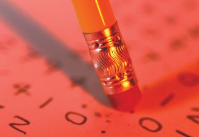 Pencil eraser erasing text from paper