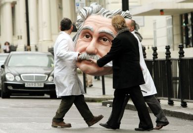 People carrying model of Albert Einstein's head, Science Museum, London, England