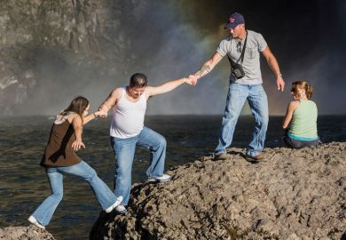 People climbing rocks, Snoqualmie Falls, Washington
