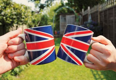 People holding Union Jack flag tea cups People holding Union Jack flag tea cups