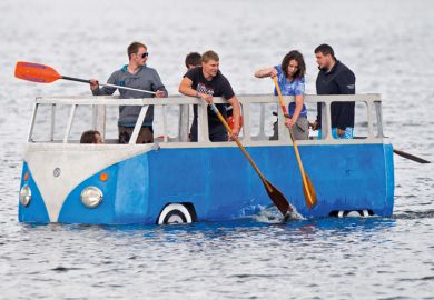 People paddling in floating Volkswagen camper van