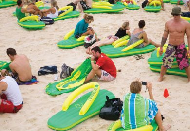People sitting on the beach on giant lilos