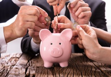 People inserting coins into piggybank