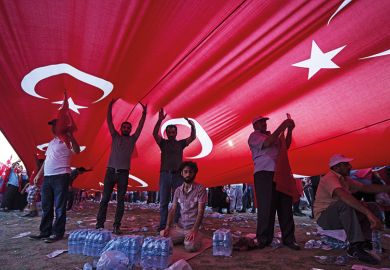 People underneath a Turkish flag