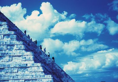 People climbing Aztec-style temple People climbing Aztec-style temple
