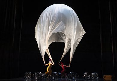 Performance with large sheet resembling umbrella