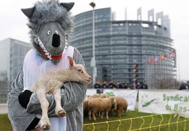 Person dressed as wolf and carrying lamb