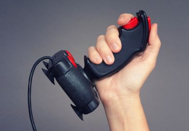 Person holding retro gaming joystick in hand Person holding retro gaming joystick in hand