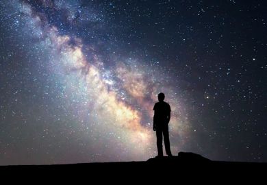 Person looking at starry night sky