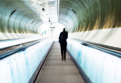 Person standing on moving walkway Person standing on moving walkway