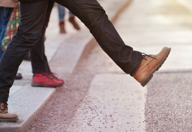 Person stepping onto pedestrian crossing Person stepping onto pedestrian crossing