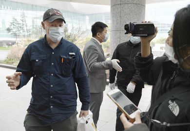 Peter Daszak (left), a member of the WHO team investigating the origins of the coronavirus pandemic, speaks at Wuhan’s airport in China on February 10, 2021, at the end of the WHO mission