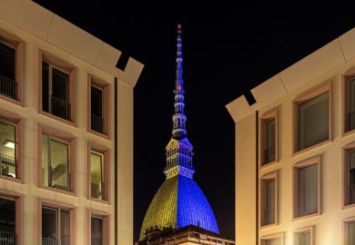 photo of mole antonelliana, monument of Turin, with the colors of the ukrainian flag. the flag was projected to demonstrate the solidity of the city to the ukraine invaded by russia.