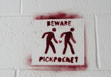 Pickpocket warning sign stencilled on to a white wall to. illustrate I’m being docked pay for boycotting marking – but I teach for free!