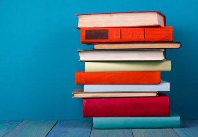 Pile of books against blue background
