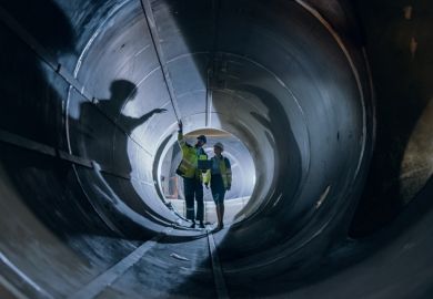Two engineers walking inside a large pipe, symbolising the skills pipeline