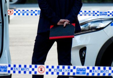 plain clothes detective holding a notebook