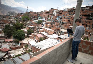 Boy with laptop on balcony Boy with laptop on balcony
