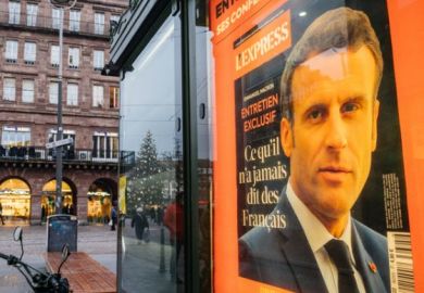 Portrait of French President Emmanuel Macron on the cover of L'Express interview advertising at press kiosk