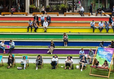 People sit on steps painted in the rainbow flag colours in support of Pride, Paddington, London. To illustrate that the public still supports EDI work in UK universities.