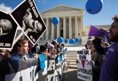 pro choice advocates (right) and anti abortion advocates (left) rally outside of the supreme court