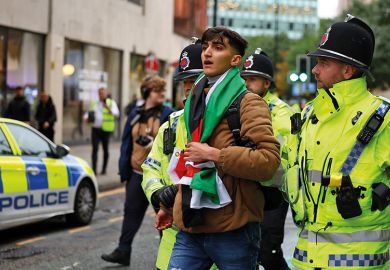 Police detain a man with a Palestine flag at a vigil for Israel held by Manchester Jewish Community in Manchester Police detain a man with a Palestine flag at a vigil for Israel held by Manchester Jewish Community in Manchester