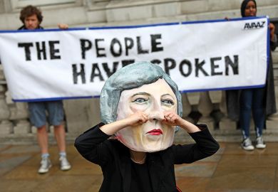 Protester in Theresa May mask