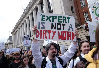 Protesters carrying signs Protesters carrying signs