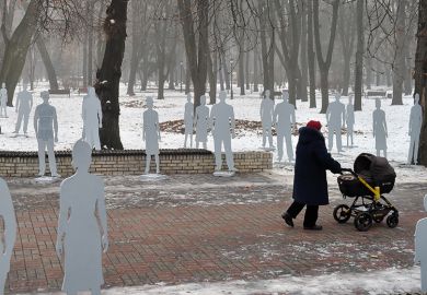 Pushing a pram in snowy park