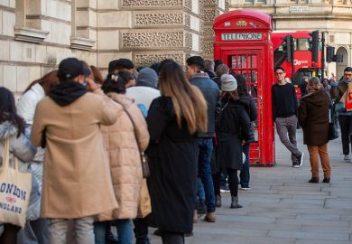 People are seen waiting in a queue for a red phone box in Westminster, London. To illustrate that free speech complaints scheme legislation is unlikely to come to fruition for several years.