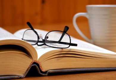 Reading glasses lying on open book