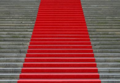 A red carpet up stairs