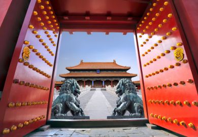 Red entrance gate opening to the forbidden city in Beijing - China