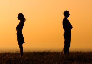 Two people in silhouette looking away from each other Two people in silhouette looking away from each other