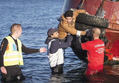 Lifeguard rescuing a man from a boat