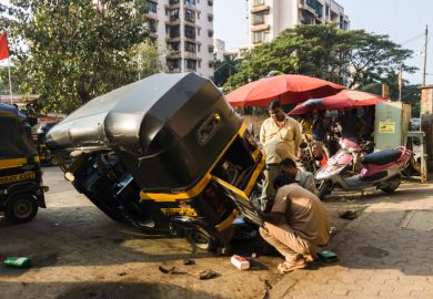 A rickshaw wheel is repaired A rickshaw wheel is repaired