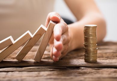 dominoes falling onto a pile of coins