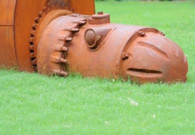 A rusty iron robot sculpture at the University of Alabama, sybolising university obsolescence