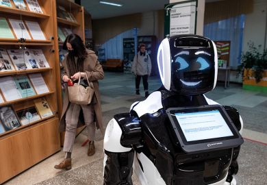 Smiling robot in a library Smiling robot illustrating a digital tool that can tell academics how decolonised their curricula are