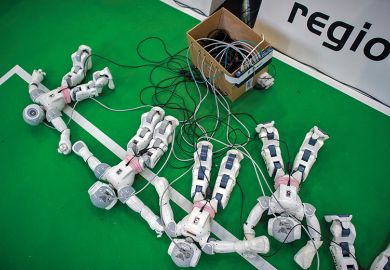 Robots charge by the play field at the 2013 RoboCup German Open tournament, illustrating an article about online cheating